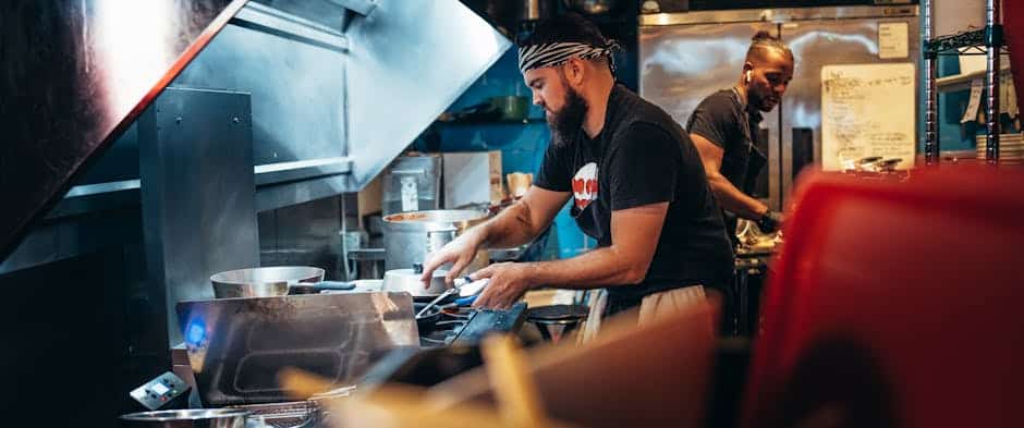 Restaurant kitchen team working during busy service